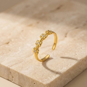 Exquisite gold flower open ring for women with cubic zirconia petals on marble