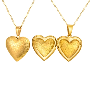 Golden heart locket necklace with floral engraving and open photo compartment
