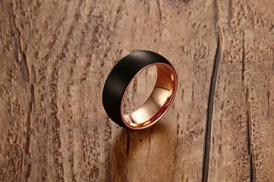 Macro shot of 8mm tungsten ring with black brushed finish and rose gold inner band