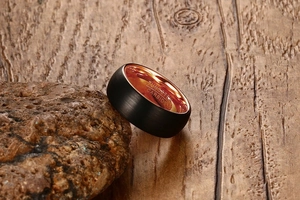 Macro shot of 8mm tungsten ring with brushed black exterior and rose gold interior