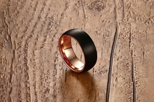 Detail of 8mm tungsten carbide ring with black brushed finish and rose gold inner band