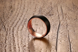 Detailed view of 8mm black brushed tungsten carbide ring with rose gold interior