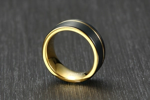 Close-up of 8mm tungsten carbide ring with black brushed finish and gold groove line