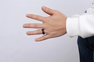 Men's 8mm matte black tungsten ring worn on finger for a stylish minimalist look