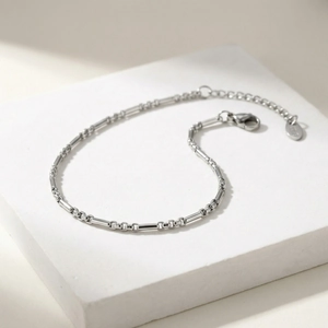 Detail showing Figaro link stainless steel anklet with lobster clasp and extension chain