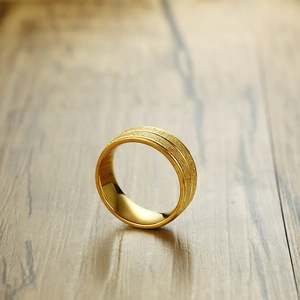 8mm gold matte finish titanium steel ring with central groove for men on wood surface