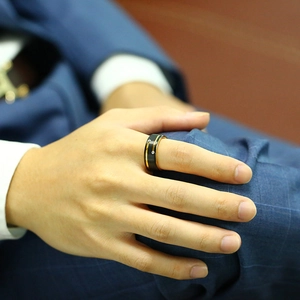 Men's black and gold tungsten ring with two zircons worn on hand for business style