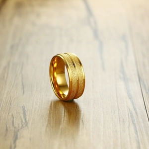 8mm gold titanium steel ring with matte brushed finish and parallel groove on wood surface