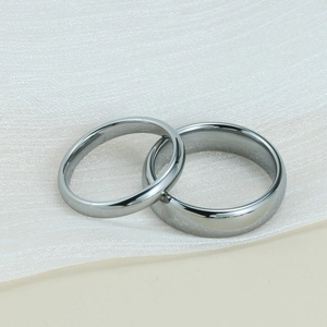 Close-up of minimalist polished dark grey tungsten rings in wide and narrow bands