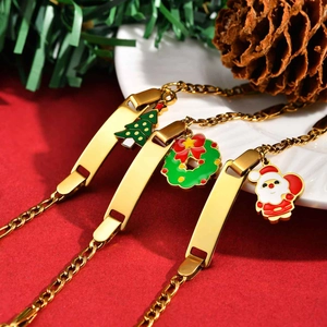 Detailed view of three gold adjustable bracelets with Christmas charms and ID plates
