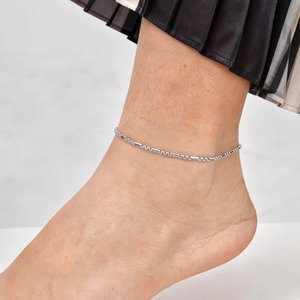 Minimalist silver Figaro ankle bracelet featuring cylindrical metal tubes and small rings