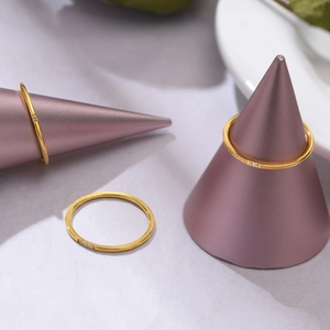 Detail of three minimalist 1mm gold stackable rings with three tiny zircons set on slim bands
