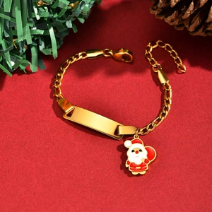 Detailed macro of gold Christmas tree bracelet with engravable bar and Santa charm