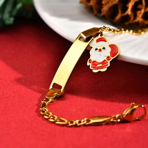 Detail of gold stainless steel bracelet with festive Santa charm and engravable ID plate