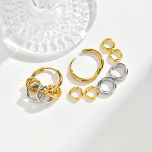 Minimalist gold and silver polished stainless steel hoop earring set on white background