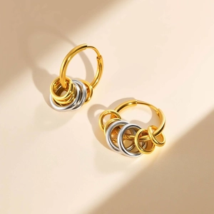 Two-tone stainless steel hoop earrings with layered gold and silver interlocking rings