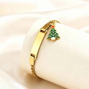 Detail of adjustable gold stainless steel bracelet with engravable bar and green Christmas tree