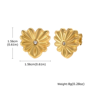 Vue détaillée de boucles d'oreilles cœur dorées avec texture et cristal central