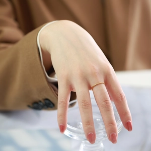 Detailed view of a 1mm gold stainless steel ring with three micro-set cubic zirconia stones