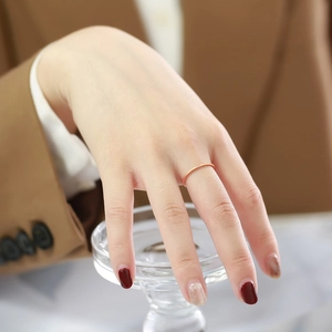 Close-up of minimalist 1mm rose gold ring with a single sparkling cubic zirconia stone