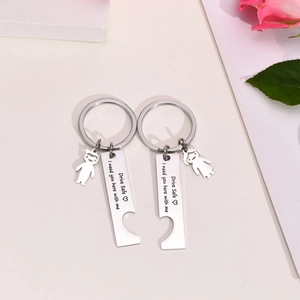 Detail showing couple keychain with Drive Safe engraving and heart puzzle charms