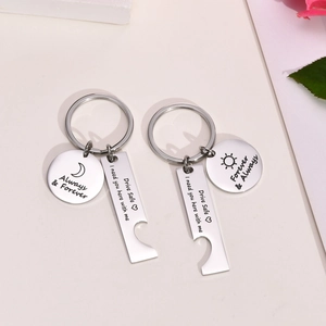 Close-up of stainless steel keychain set with Drive Safe engraving and moon sun charms