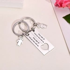 Close-up of heart puzzle stainless steel keychain engraved Drive Safe I need you here