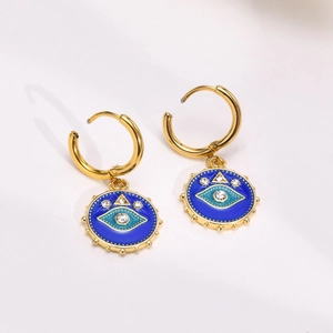 Detail of gold evil eye hoop earrings with blue enamel charms and sparkling rhinestones