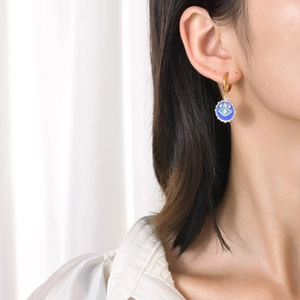 Golden stainless steel evil eye charm earrings with blue enamel and fine crystals