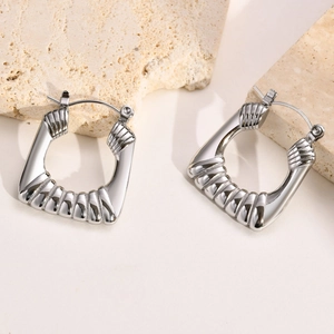 Detailed view of silver irregular square earrings with horizontal striped texture on stone