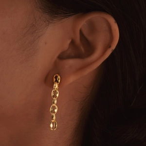 Elegant gold stainless steel coffee bean chain drop earrings for women on model