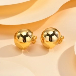 Elegant gold spherical earrings with liquid metal design on a layered beige background