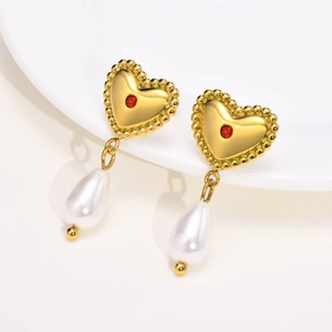 Gold heart earrings with red zircon and teardrop pearls on a clean white background