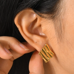 Gold rectangular stud earrings with a wavy texture and geometric minimalist style