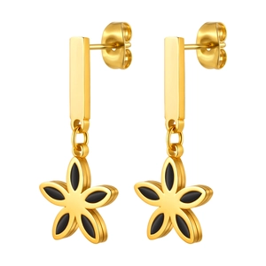 Close-up of gold stainless steel flower earrings with black enamel petal centers