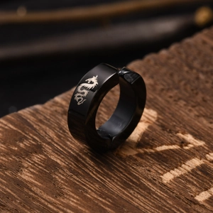 Men's matte black stainless steel clip-on earring featuring a silver dragon engraving