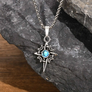 Macro view of Celtic star and moon pendant with blue gemstone on textured dark rock