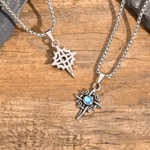 Detail of Celtic moon starburst pendants with blue gemstone on rustic stone and wood