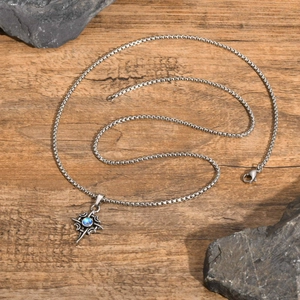 Detail of Celtic stainless steel necklace with moonstone star pendant on wooden surface
