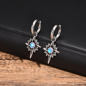 Detailed close-up of Celtic star earrings with moonstone on a black leather box