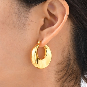 Modern minimalist chunky golden C-shaped hoop earrings with a polished mirror finish