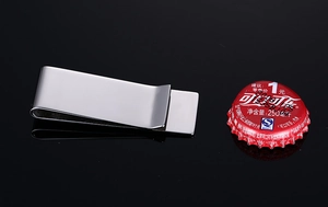 Close-up of a polished stainless steel money clip with a sleek mirror finish surface