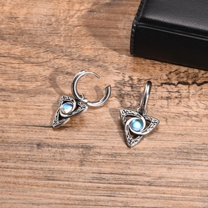 Detailed macro view of Celtic knot earrings with celestial moonstone inlay and silver finish