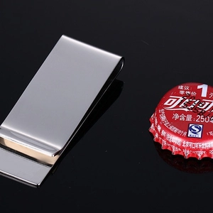 Polished stainless steel money clip with minimalist U-shaped design on a black surface
