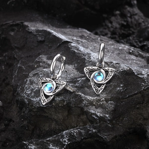 Celtic stainless steel moonstone drop earrings on dark stone background