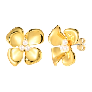 Exaggerated golden flower earrings with white pearls and minimalist organic design