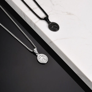 Detailed view of silver and black oval cross pendants with textured backgrounds
