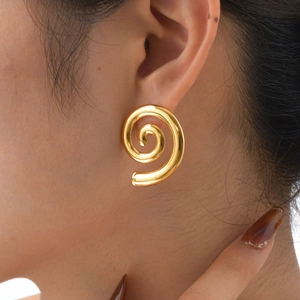 Close-up of a model wearing minimalist 18K gold-plated spiral stud earrings in a tube design