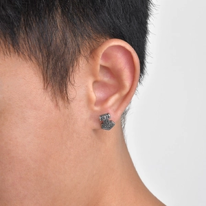 Close-up of vintage Mjolnir stud earring in stainless steel worn on male ear model