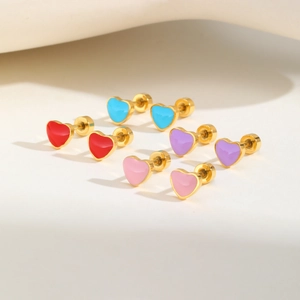 Detail view of colorful heart stud earrings in red blue pink and purple with gold plating